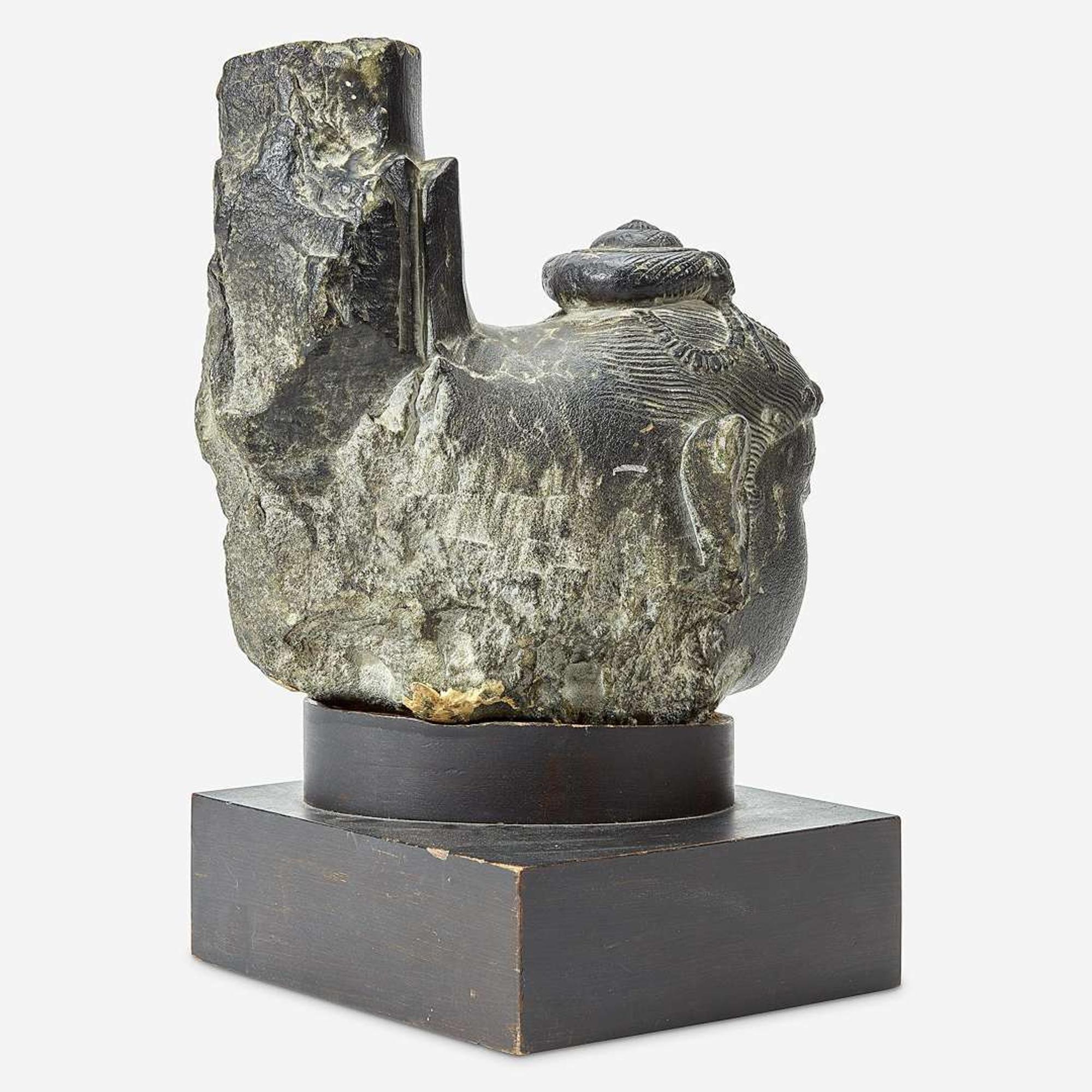 An Indian carved black stone head of a female Gahadavala Dynasty, 12th Century