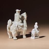 Two Chinese Blanc-de-Chine Porcelain Figural Groups of Foreigners Riding on Qilin, Late 17th-Early 18th Century — 清中期 德化白瓷骑麒麟西人像兩件