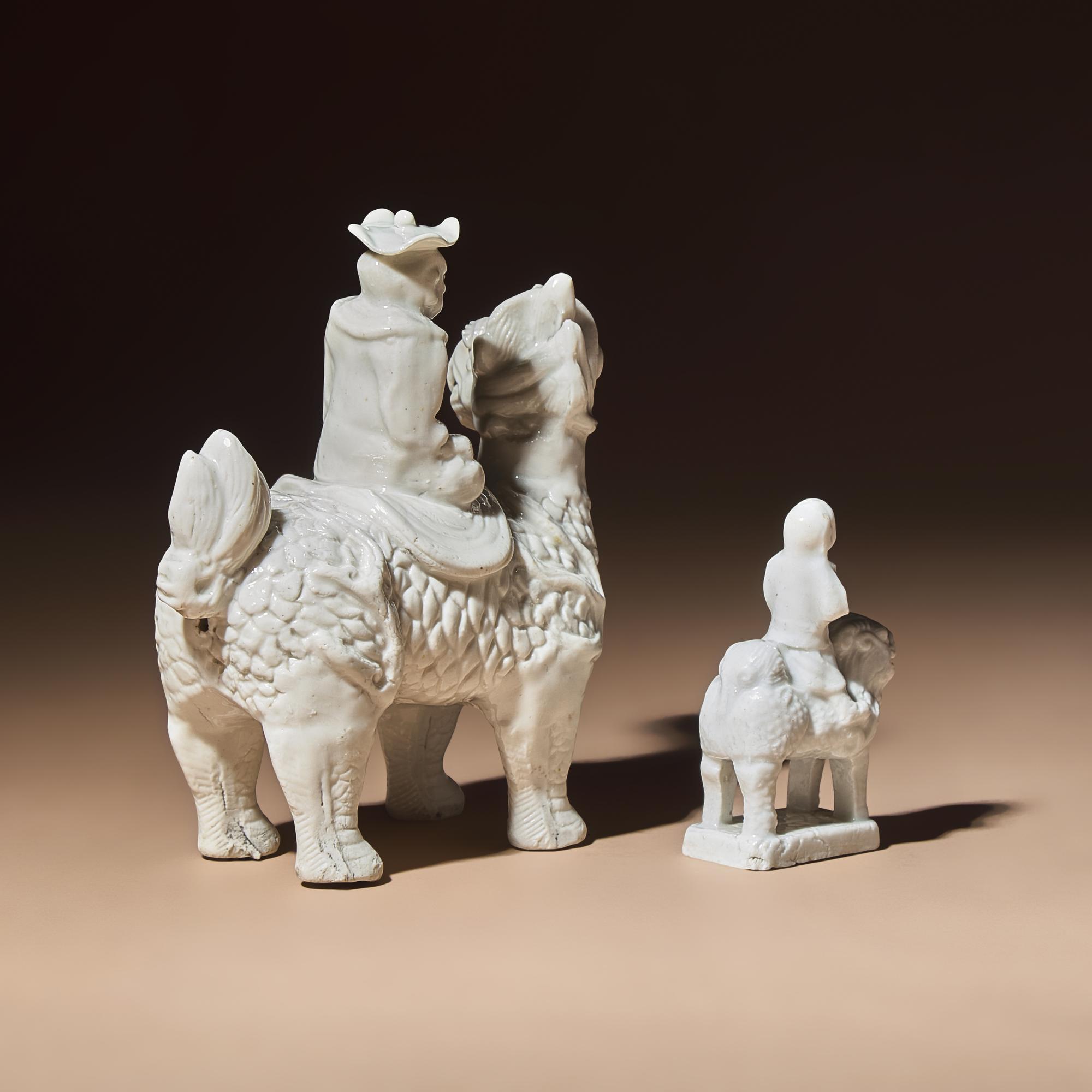 Two Chinese Blanc-de-Chine Porcelain Figural Groups of Foreigners Riding on Qilin, Late 17th-Early 18th Century — 清中期 德化白瓷骑麒麟西人像兩件