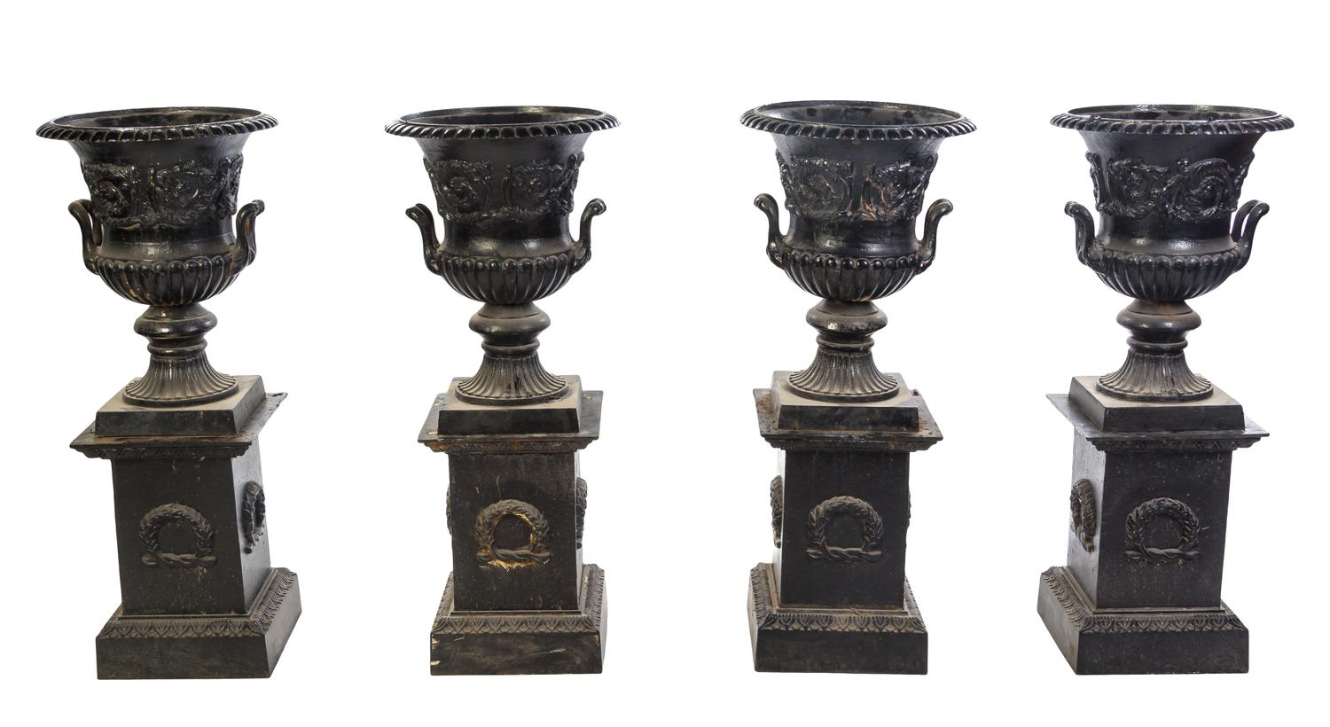 A Set of Four Victorian Style Cast Iron Urns on Stands, Height overall 42 1/2 inches.
