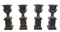 A Set of Four Victorian Style Cast Iron Urns on Stands, Height overall 42 1/2 inches.