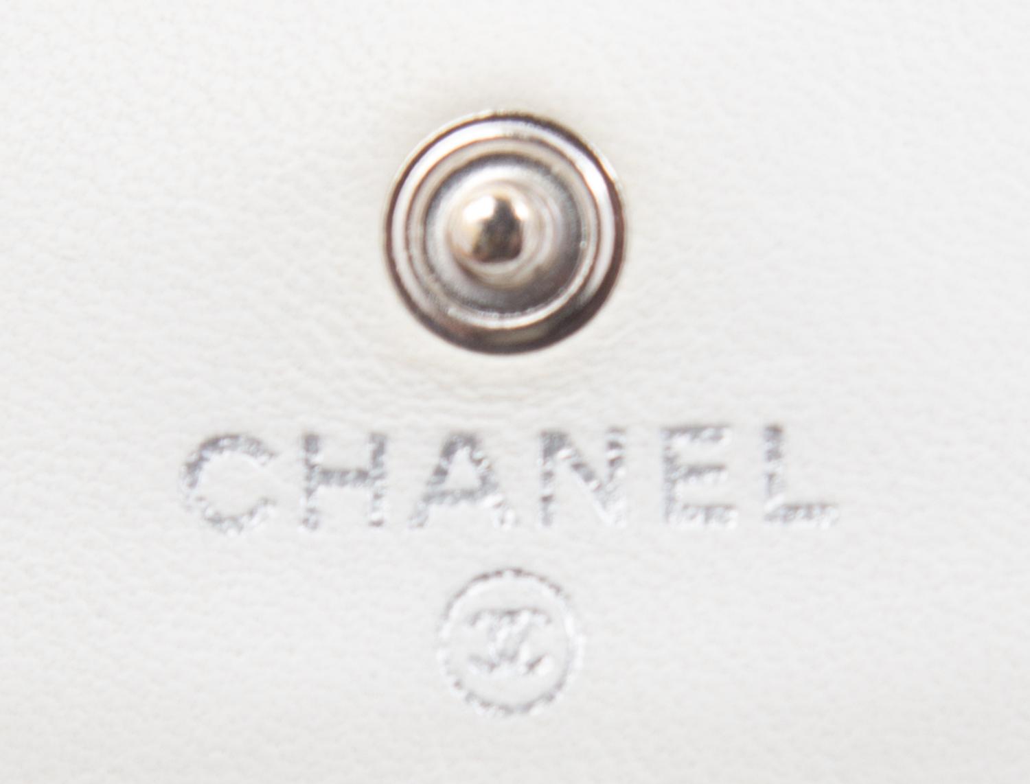 A Chanel White Dot Flap Handbag, 7.5" x 5" x 1".