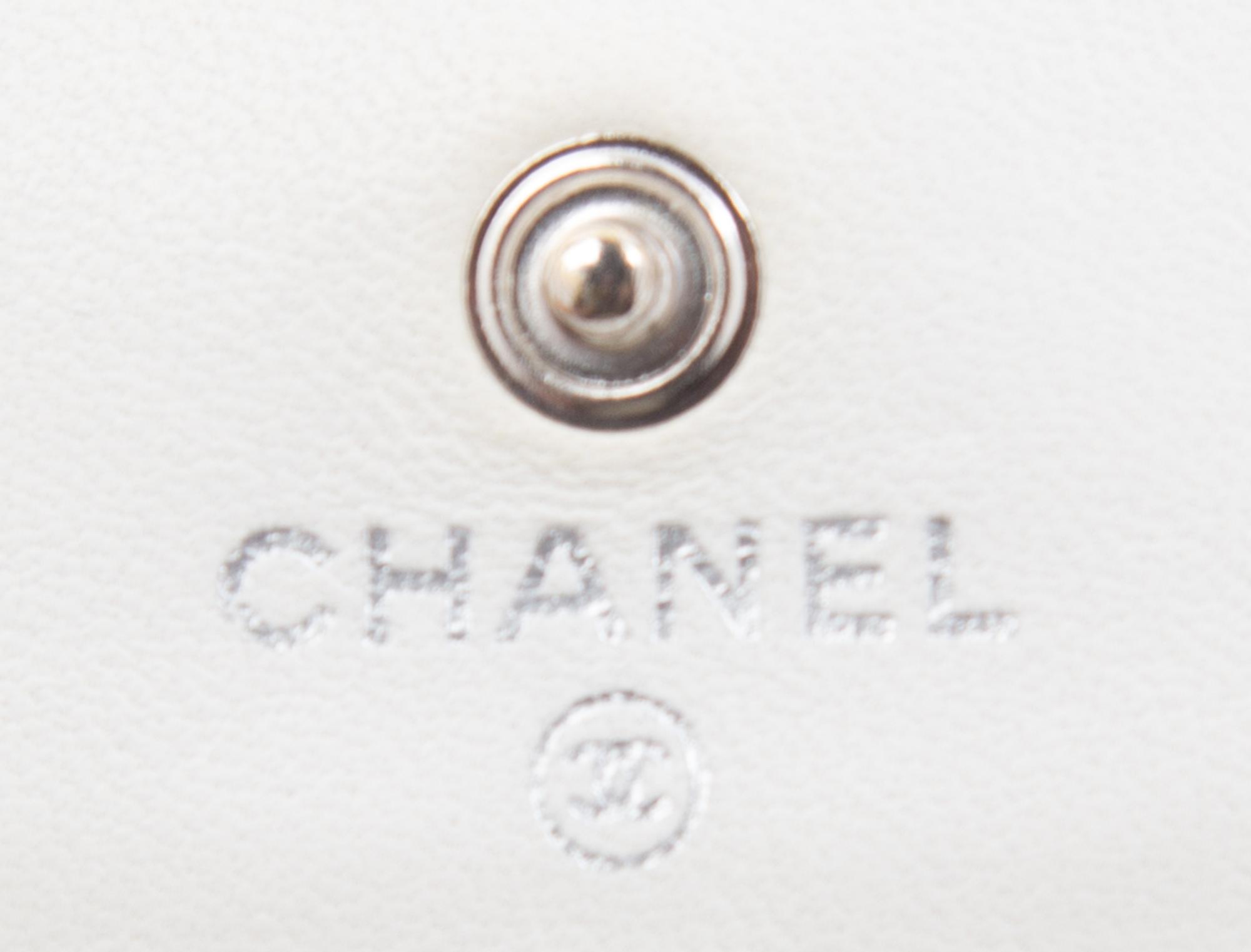 A Chanel White Dot Flap Handbag, 7.5" x 5" x 1".