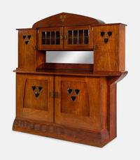 An Austrian Secessionist Inlaid Dining Suite, comprising a sideboard, a server, an extension dining table with five leaves, six side chairs and four armchairs