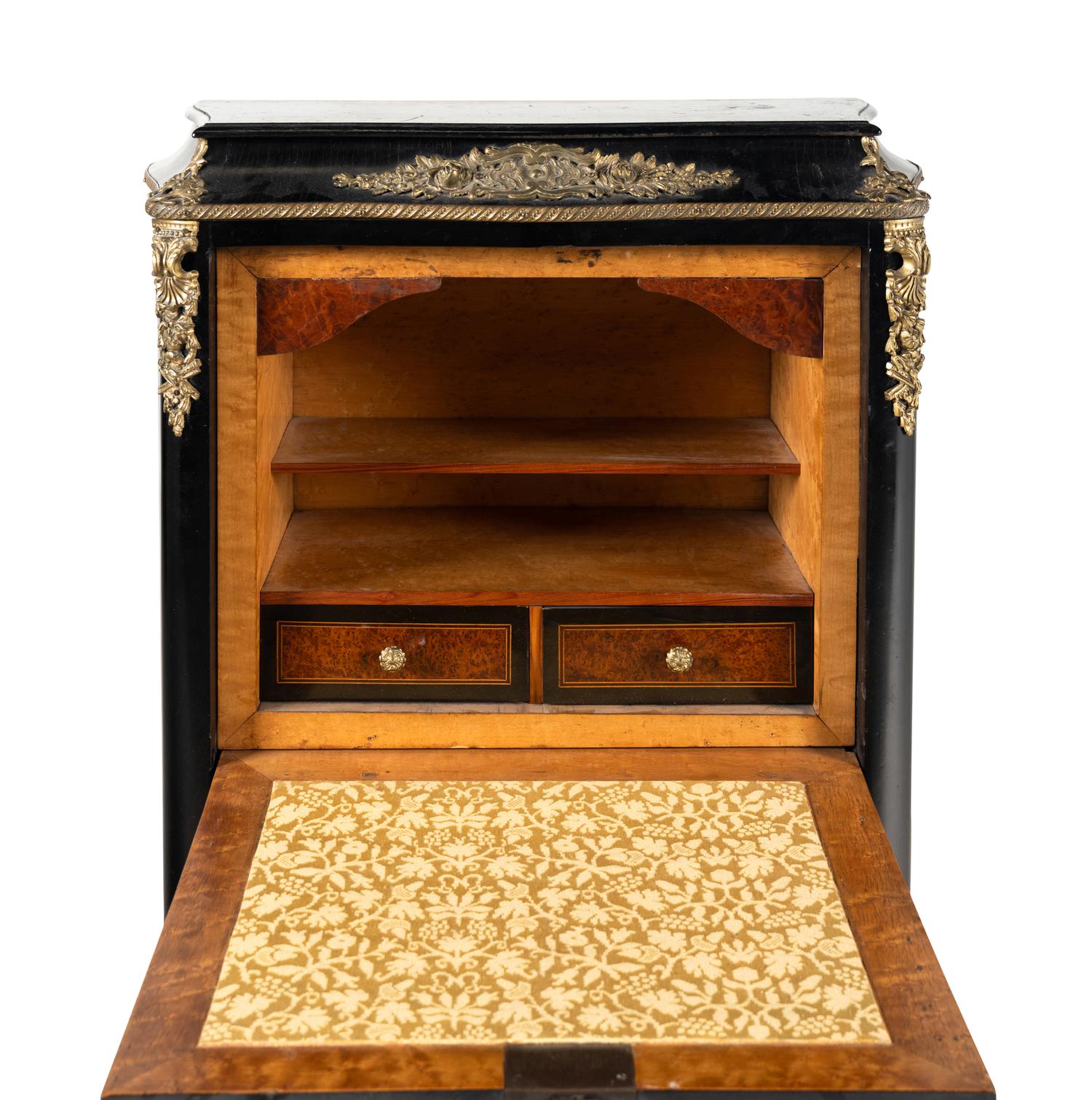 A Napoleon III Style Gilt Bronze Mounted Ebonized Semainier