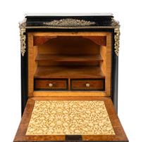A Napoleon III Style Gilt Bronze Mounted Ebonized Semainier