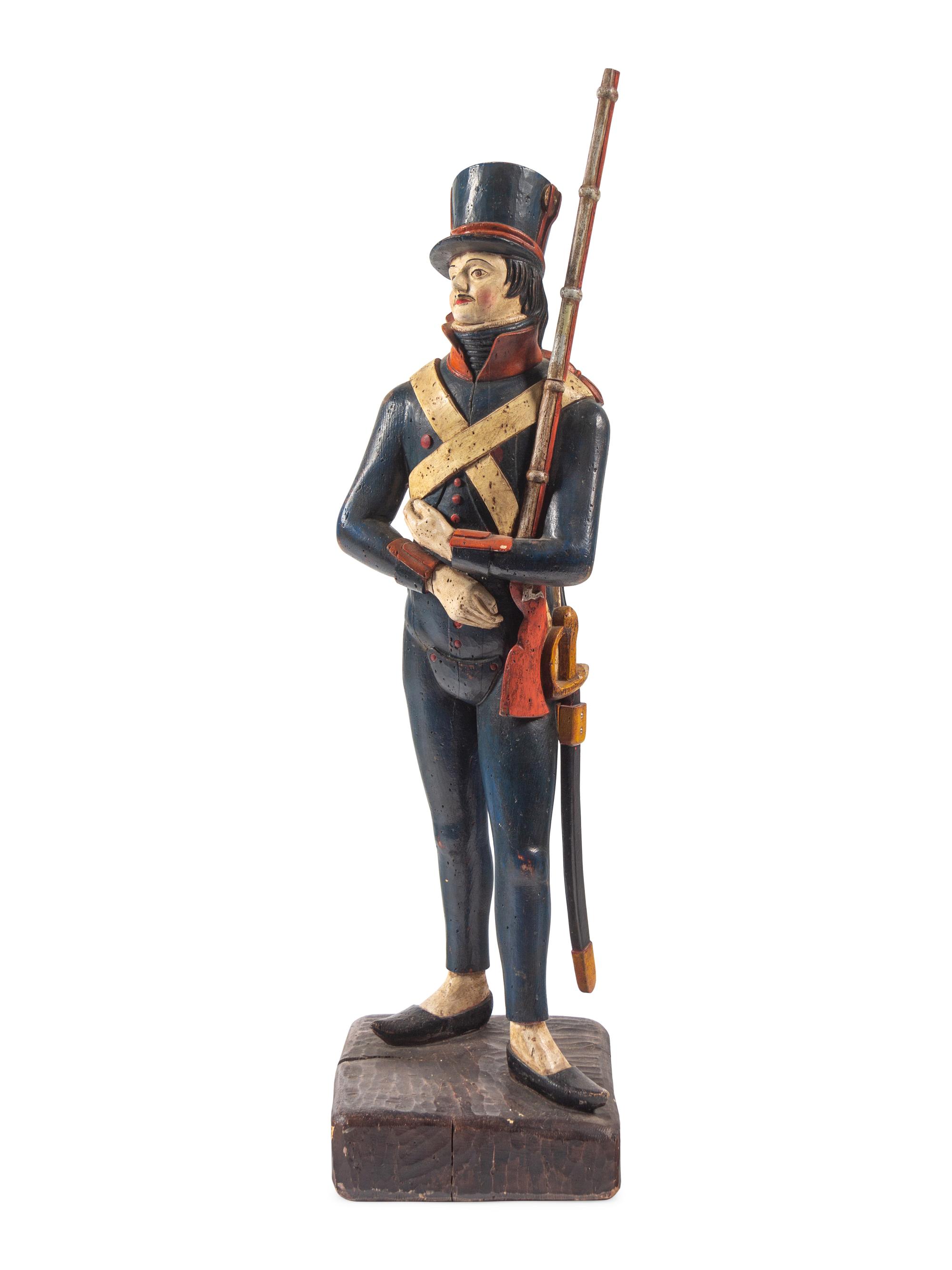 A Carved and Painted Wood Figure of a Soldier