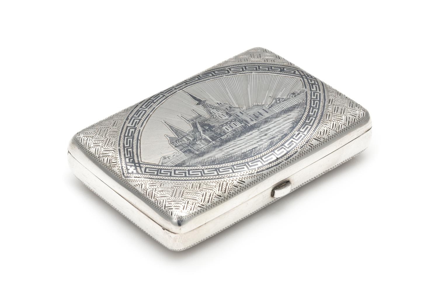 A Russian Niello Silver Cigarette Case, Maker's Mark CEC, Early 20th Century, the lid centered by a Slavic town scene, the underside wi