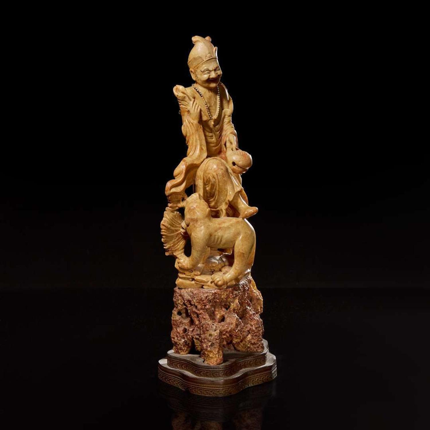 A Chinese carved beige soapstone figure of an immortal or monk with tiger 壽山石雕伏虎羅漢 Republic period or earlier ?????