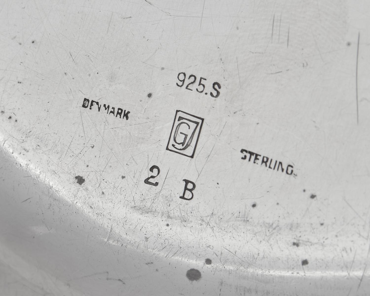 A Set of Nine Georg Jensen Silver Blossom Pattern Bread Plates