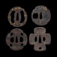 Group of eight Japanese inlaid iron tsuba Edo period or earlier