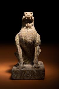 A Carved Puddingstone Figure of a Seated Lion