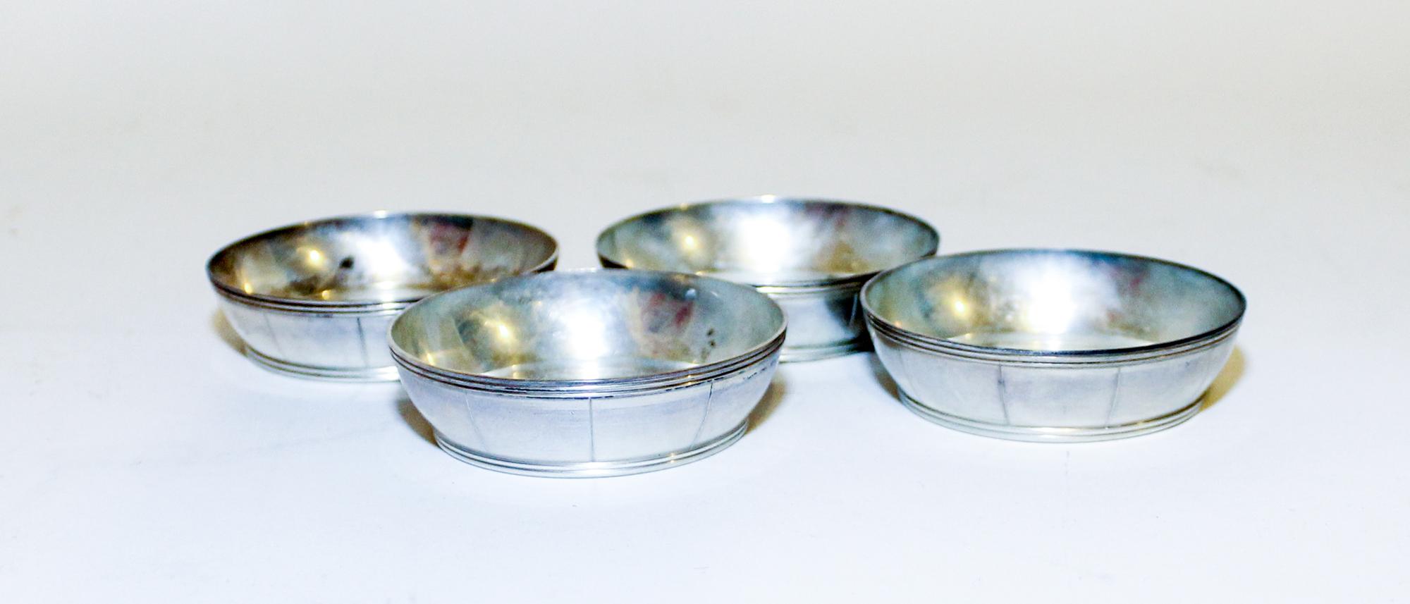 A Set of Four American Silver Butter Dishes, Tiffany & Co., New York, NY, or circular form with reeded banding along rim and base.