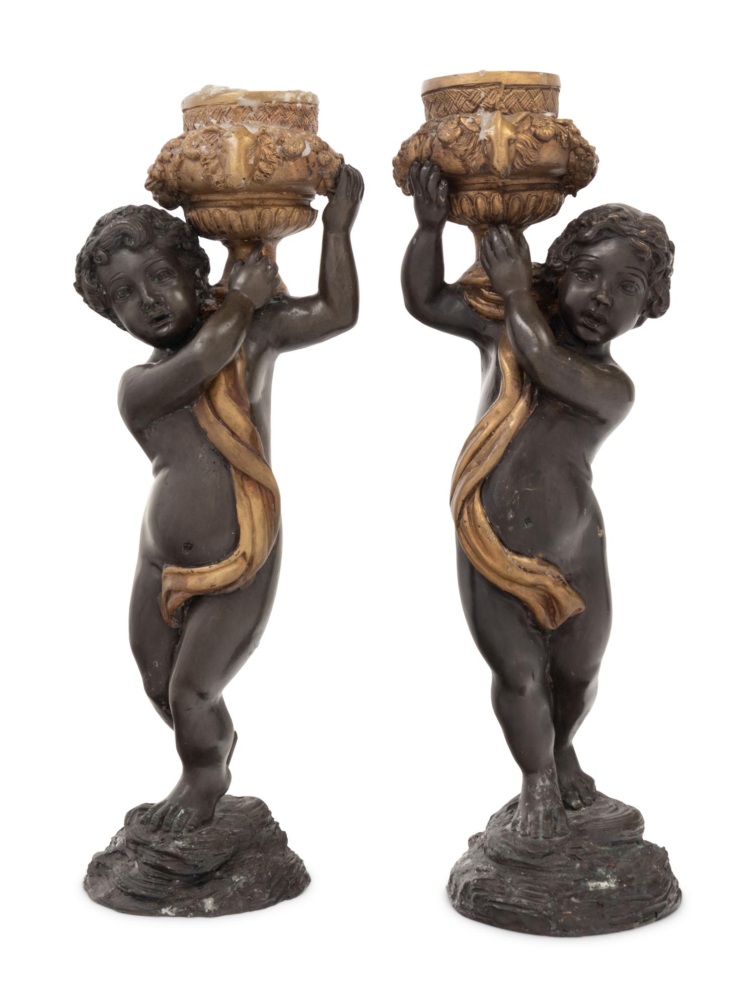 A Pair of Gilt and Patinated Bronze Figures of Cherubs