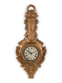 A Louis XVI Style Giltwood Cartel Clock