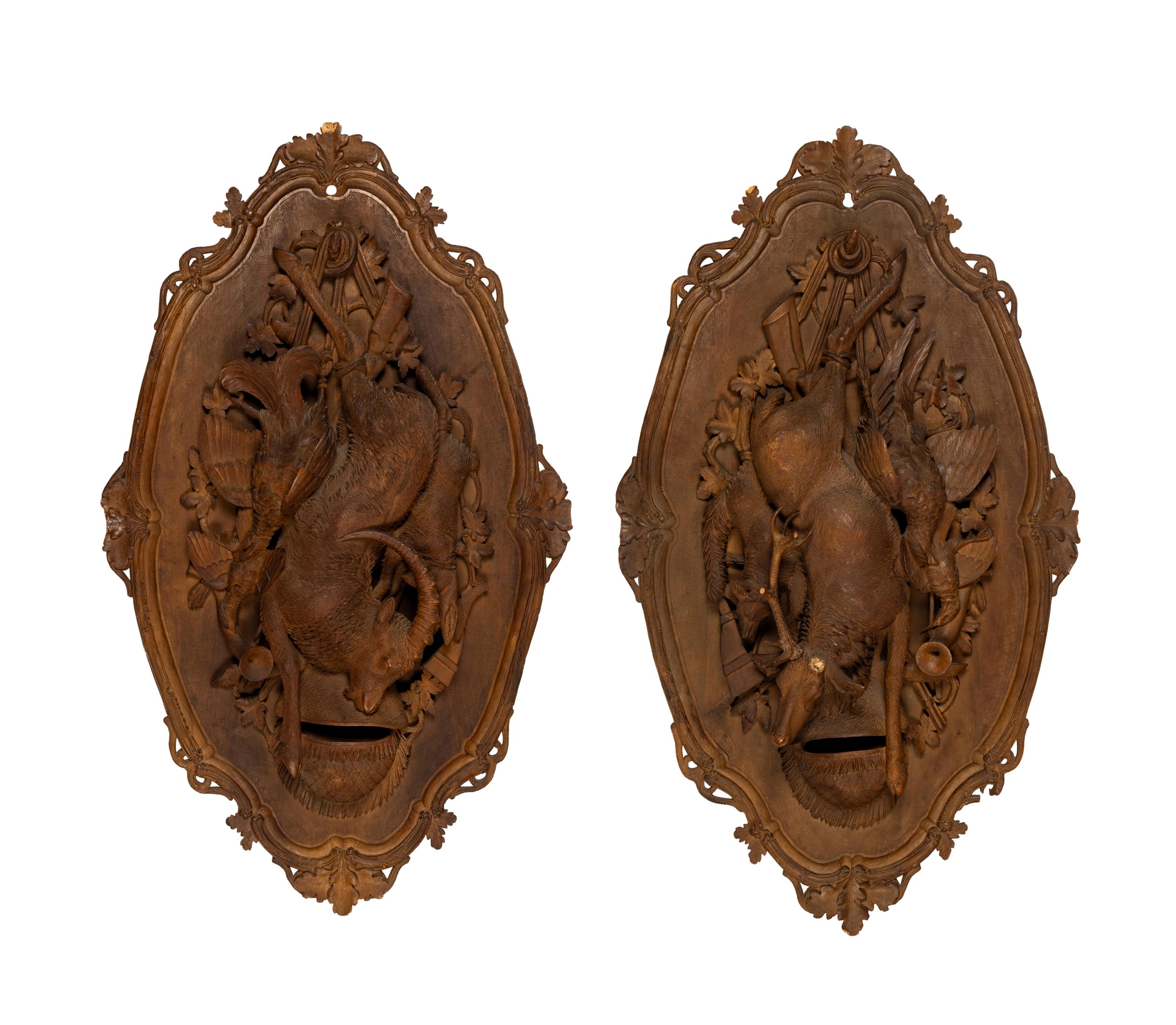 A Pair of Swiss "Black Forest" Carved Lindenwood Game Plaques