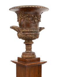 A Pair of Neoclassical Style Carved Campagna Form Urns on Pedestals
