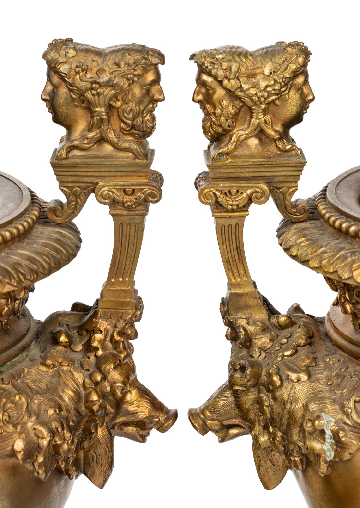 A Pair of Neoclassical Gilt Bronze Urns on Marble Plinths