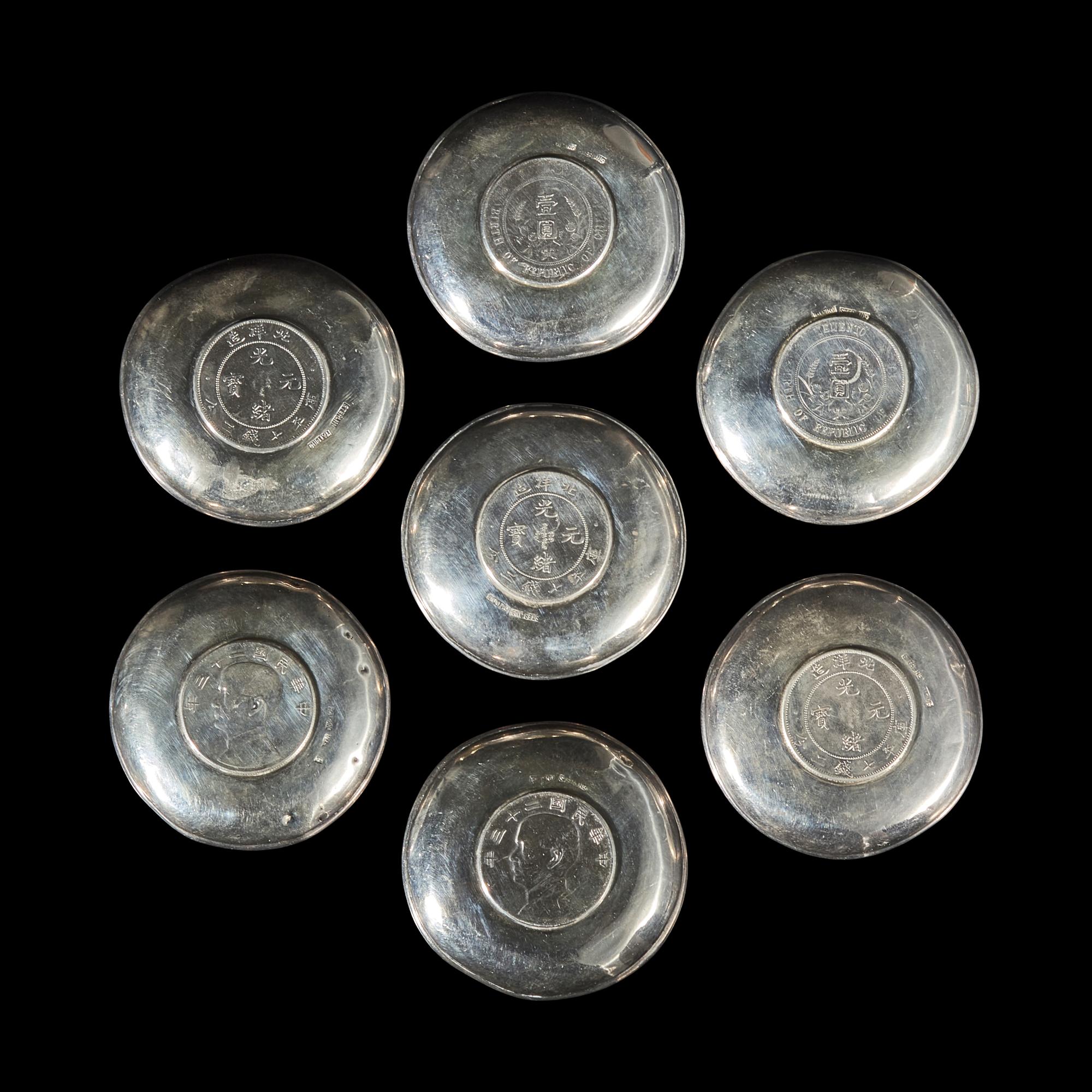 A Group of Seven Chinese Silver Coin-Mounted Small Dishes, 20th Century — 近代 銀嵌機制幣小碟一組七件