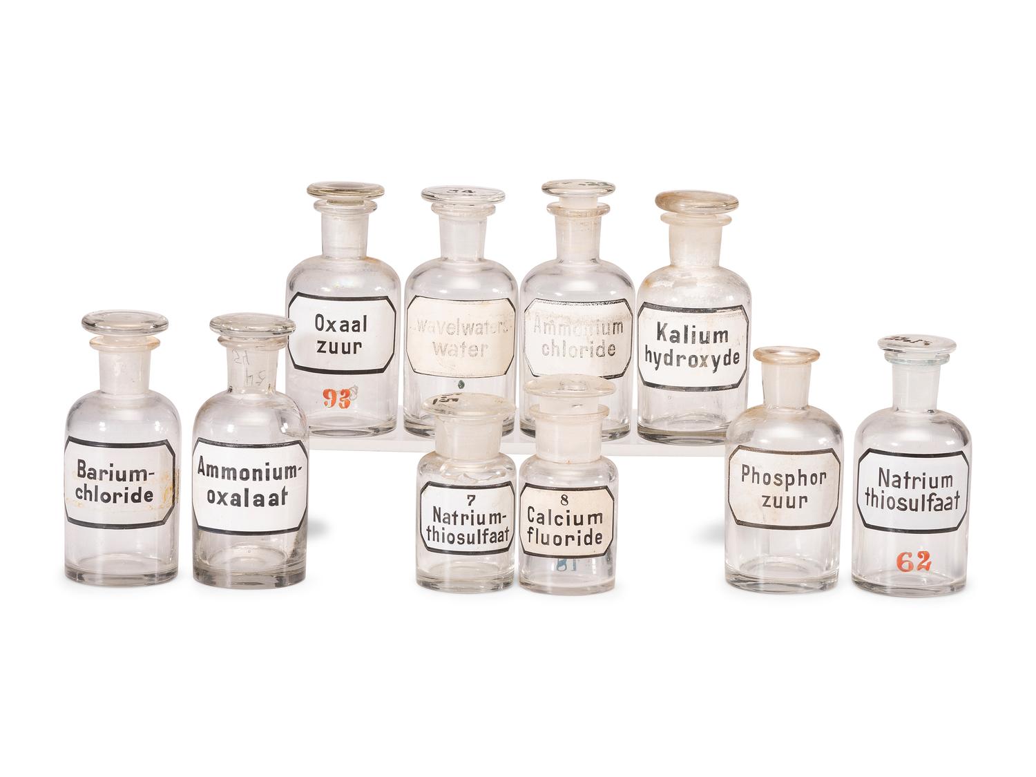 A Group of Advertising Paperweights and Glass Apothecary Bottles