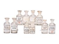 A Group of Advertising Paperweights and Glass Apothecary Bottles