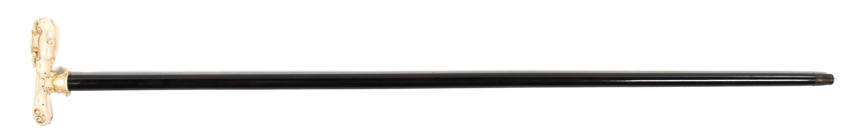 A Continental Carved Ivory Cane Handle, Height overall 38 1/4 x width of handle 5 inches.