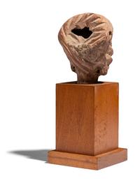 An Egyptian Terracotta Head of a Woman