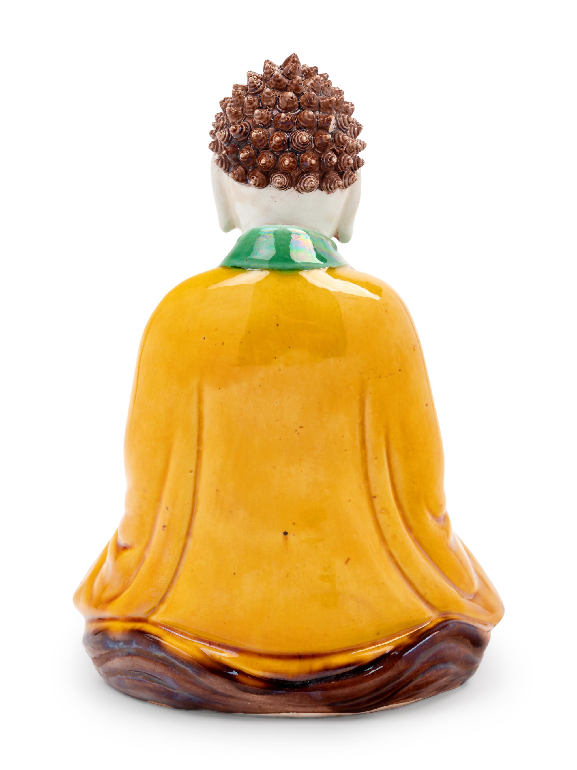 A Chinese Sancai Glazed Biscuit Figure of Buddha Shakyamuni