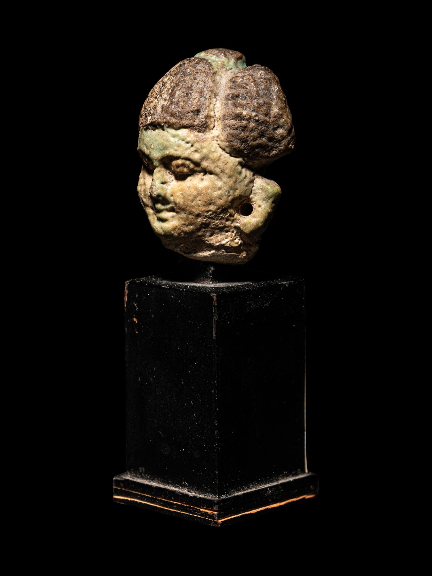 An Egyptian Faience Head of a Concubine