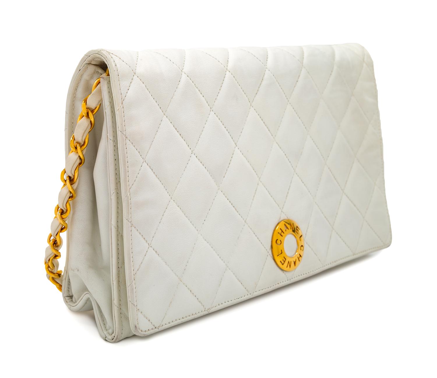 A Chanel White Lambskin Flap Clutch/Bag, 7" H x 10" W x 2" D; Strap drop: 17".