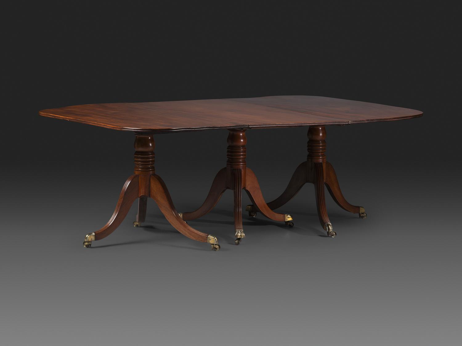 A Late Chippendale Flame Mahogany Triple Pedestal Dining Table