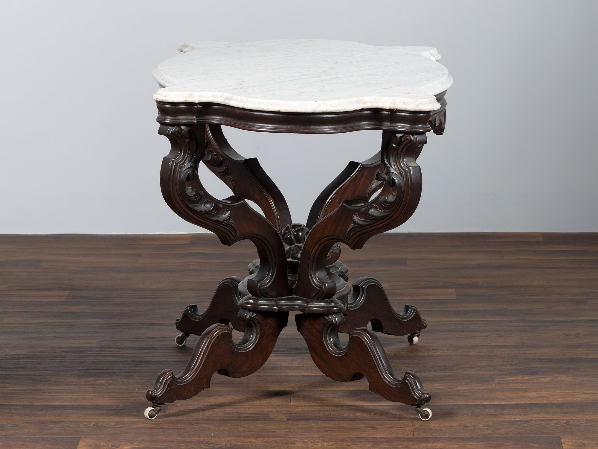 A Renaissance Revival Carved Walnut Marble Top Center Table