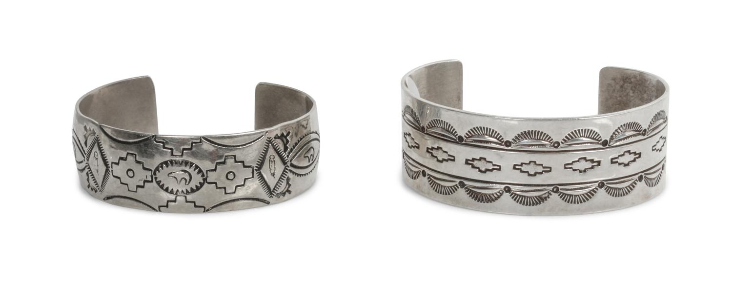 Two Traditional Style Navajo Stamped Silver Bracelets Length of larger 5 5/8 x opening 1 3/8 x width 1 inches.
