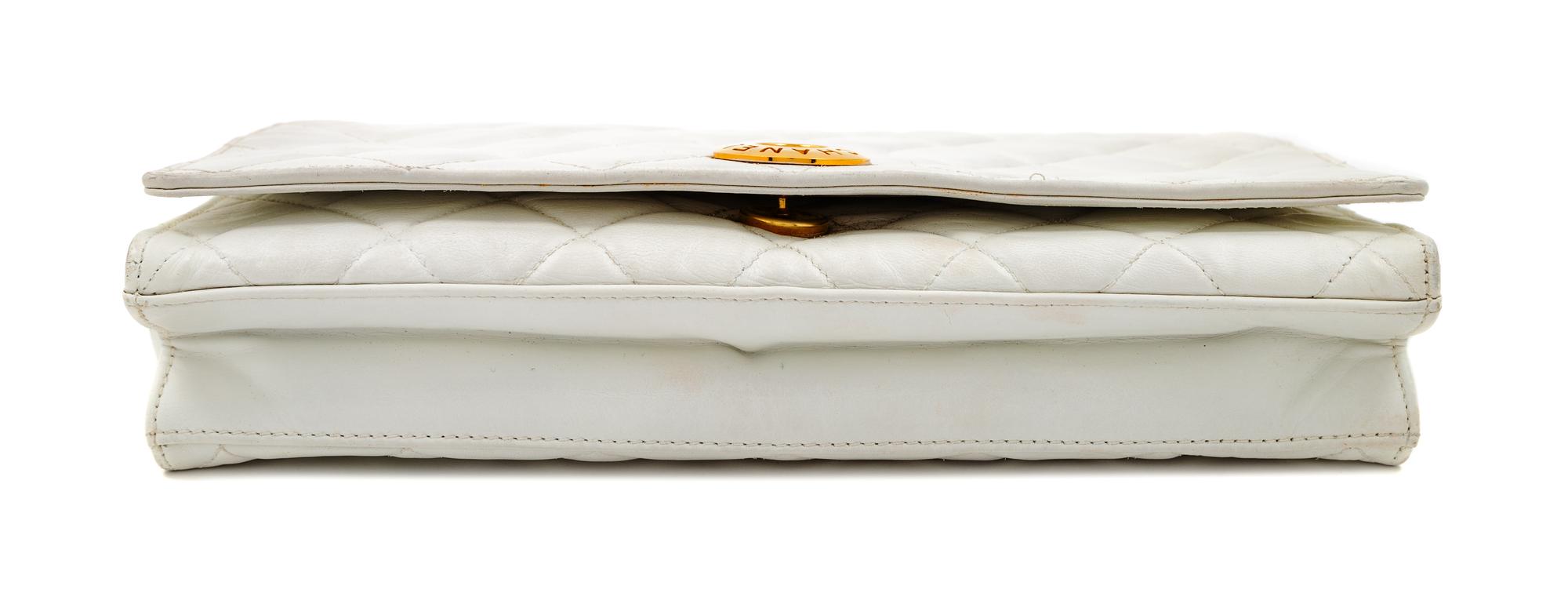 A Chanel White Lambskin Flap Clutch/Bag, 7" H x 10" W x 2" D; Strap drop: 17".