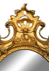 A Louis XV Style Giltwood Oval Mirror — LATE 18TH/EARLY 19TH CENTURY