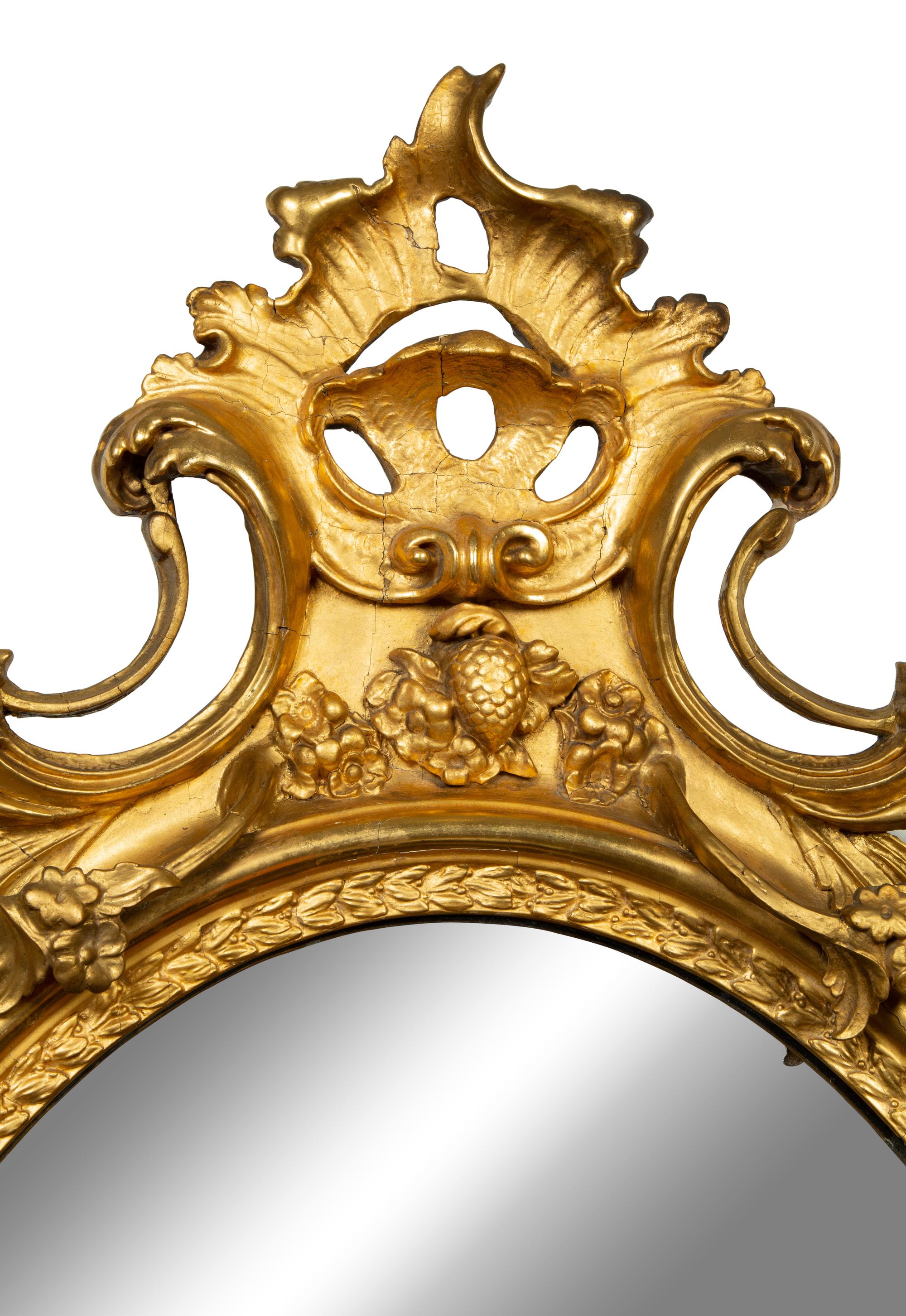 A Louis XV Style Giltwood Oval Mirror — LATE 18TH/EARLY 19TH CENTURY