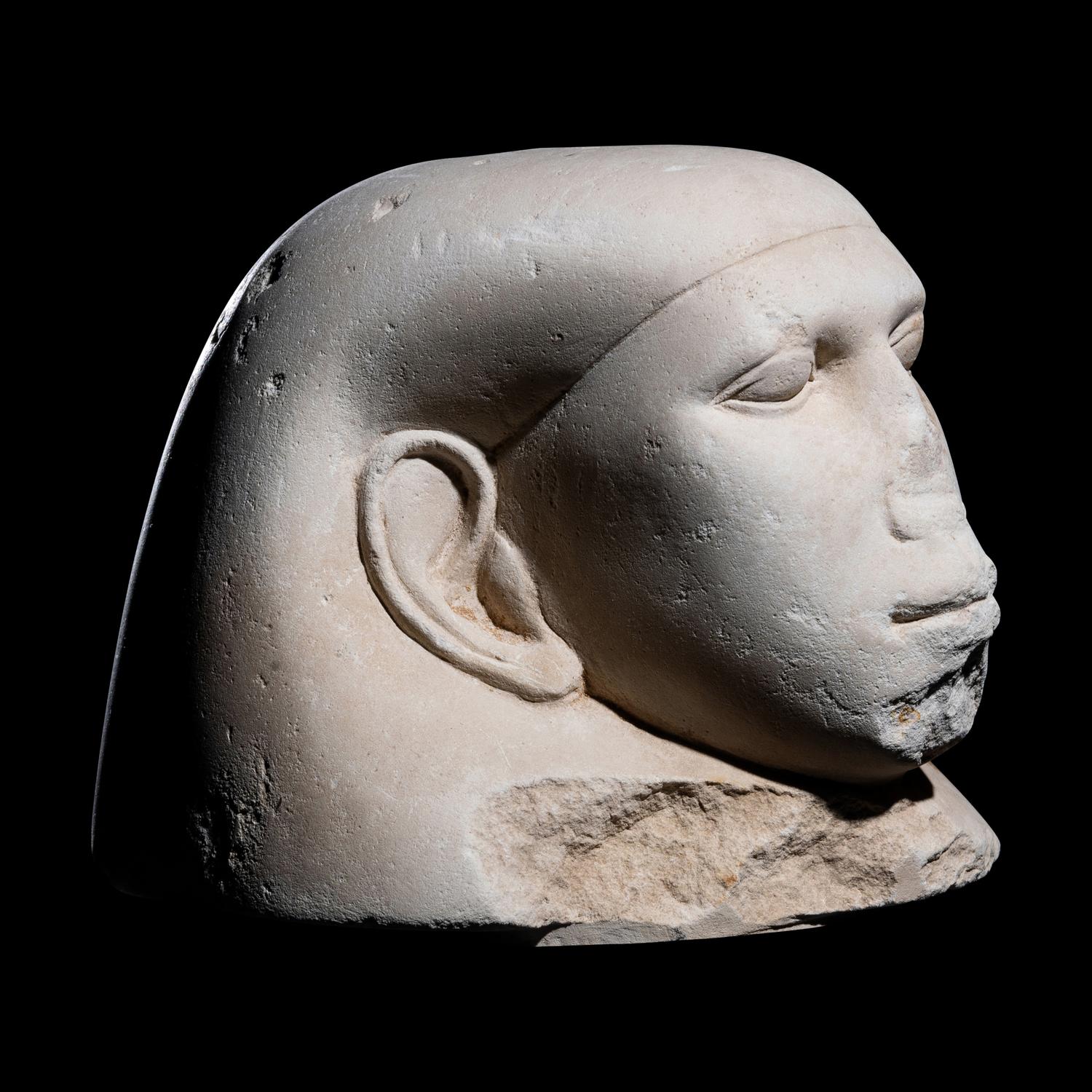 An Egyptian Limestone Canopic Jar Lid