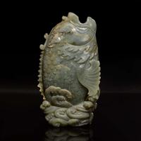 A Chinese carved celadon jade figure of a leaping carp 青玉鯉躍龍門花插