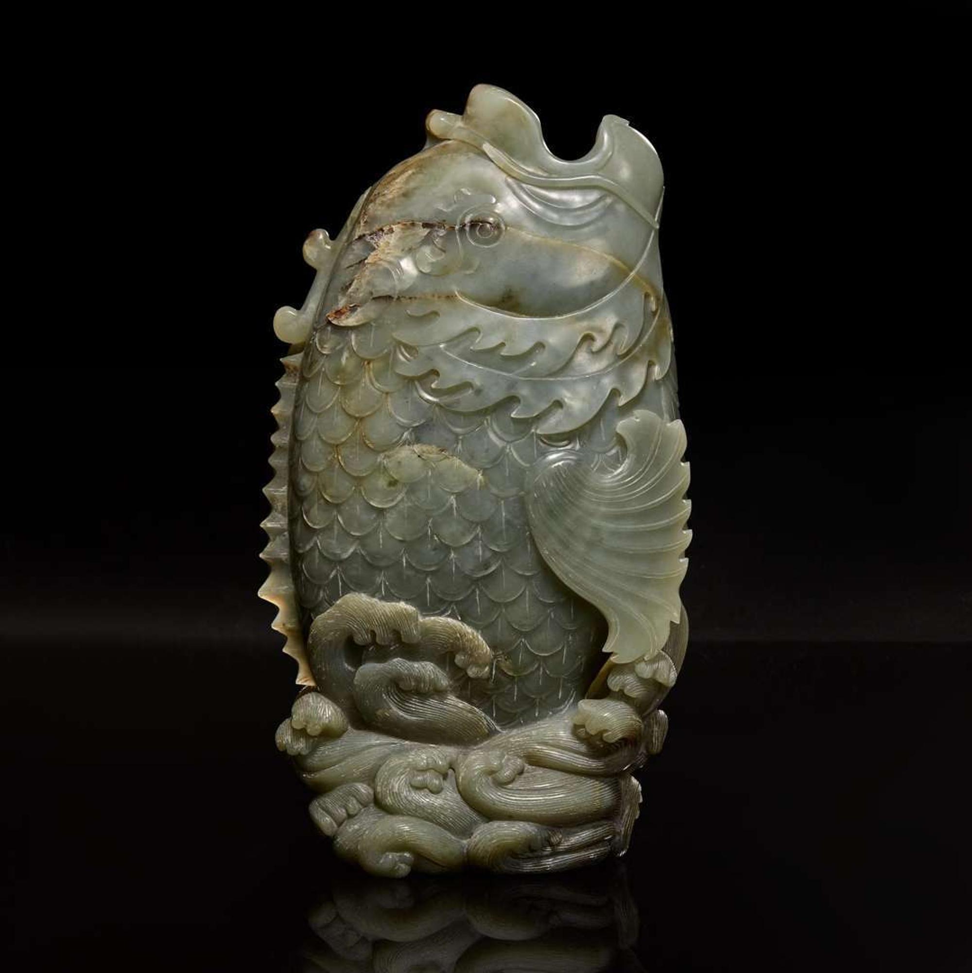 A Chinese carved celadon jade figure of a leaping carp 青玉鯉躍龍門花插