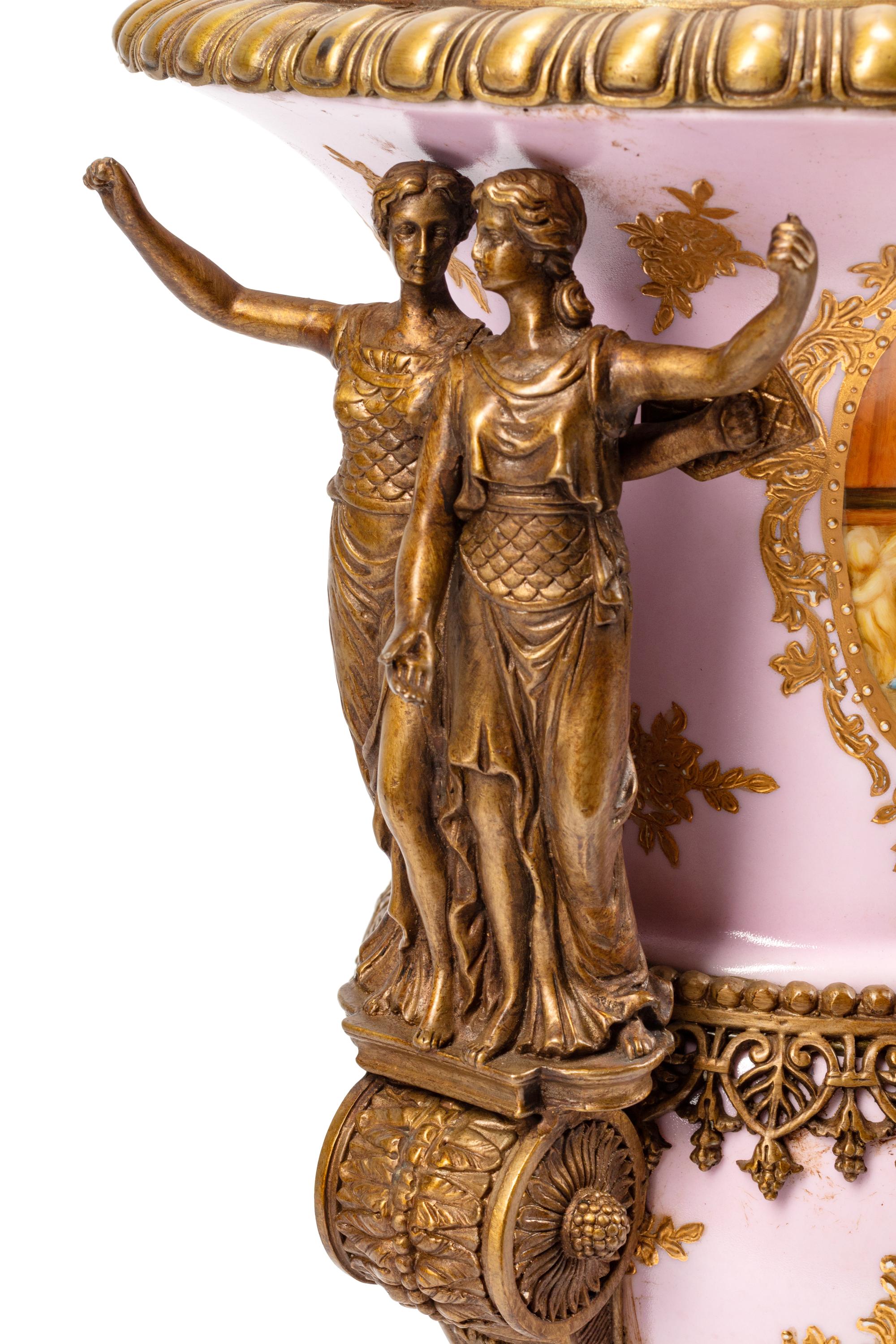A Pair of Sèvres Style Gilt Bronze Mounted Porcelain Urns