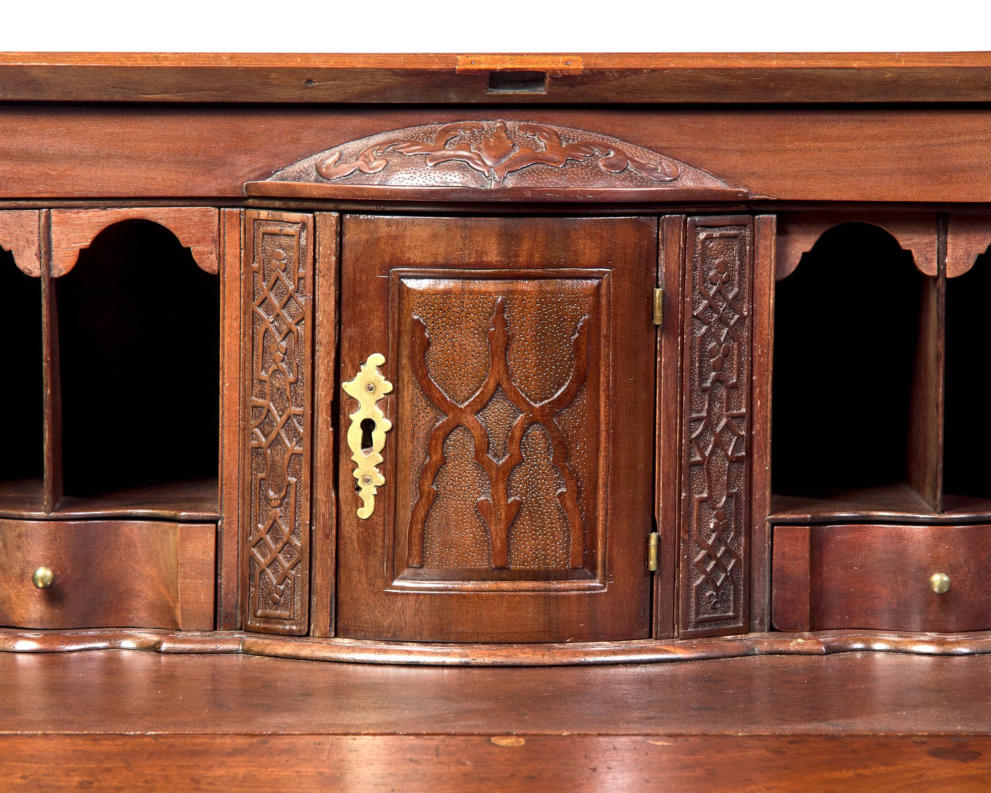 A Chippendale Carved Mahogany Serpentine-Front Slant-Front Desk