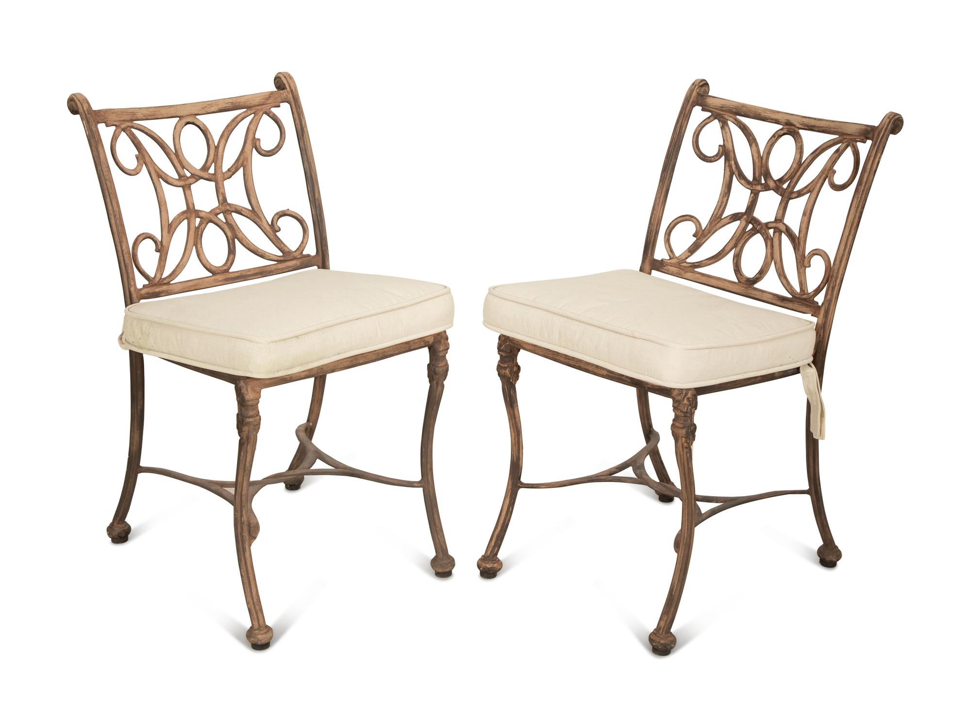 A Pair of Patinated Metal Garden Chairs and Side Table