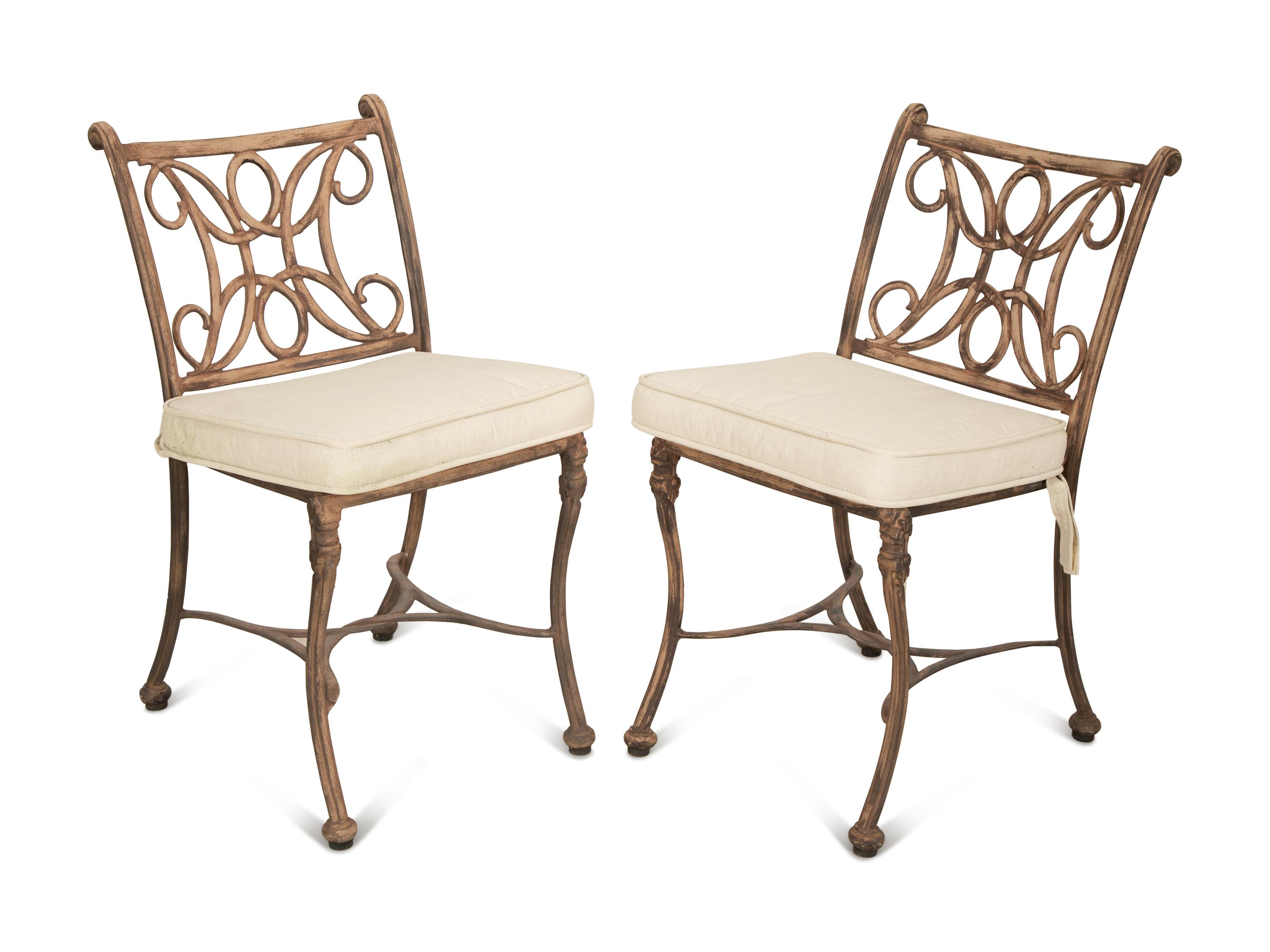 A Pair of Patinated Metal Garden Chairs and Side Table