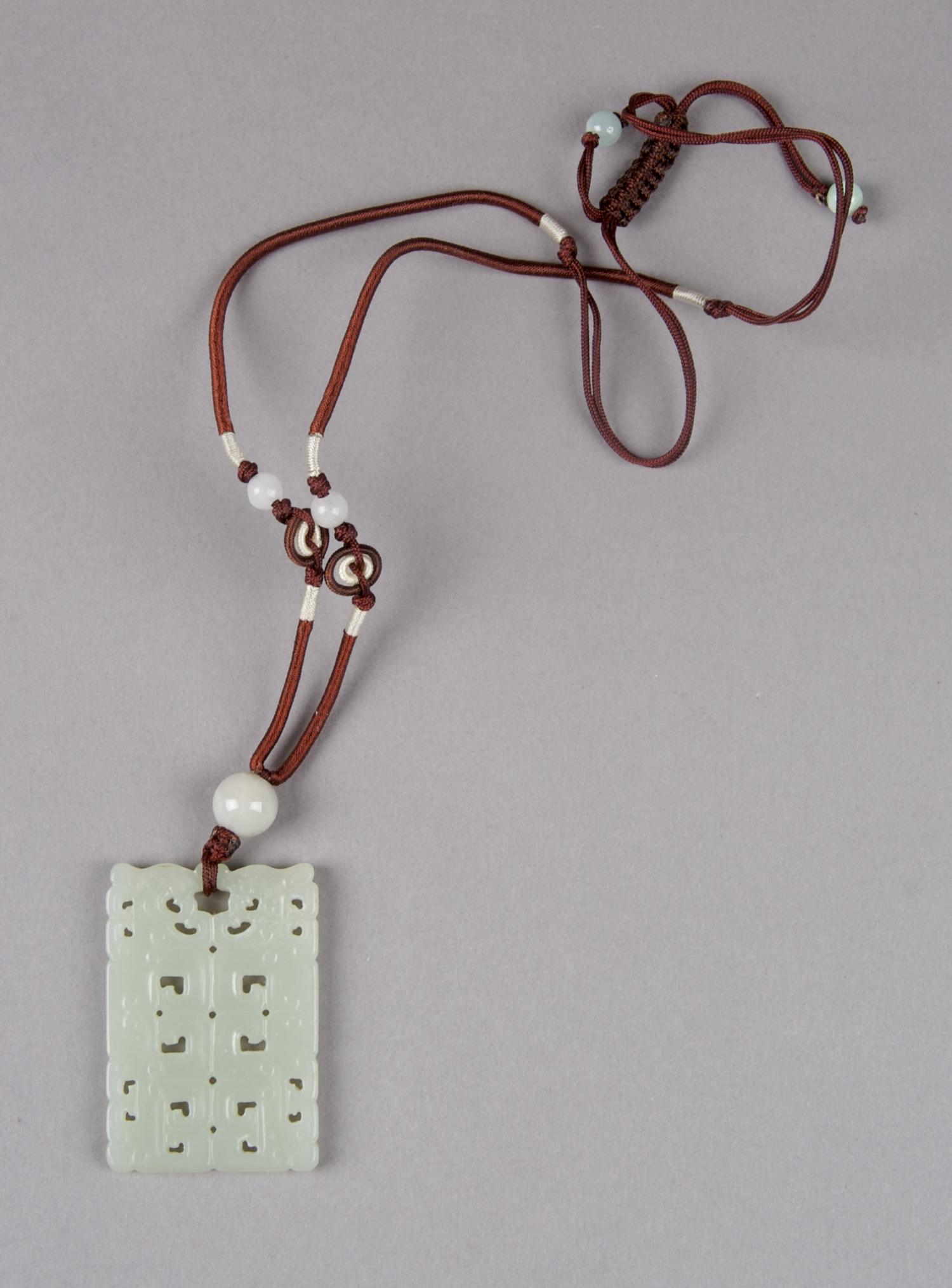 A Celadon Jade Rectangular Plaque, Height 2 inches.