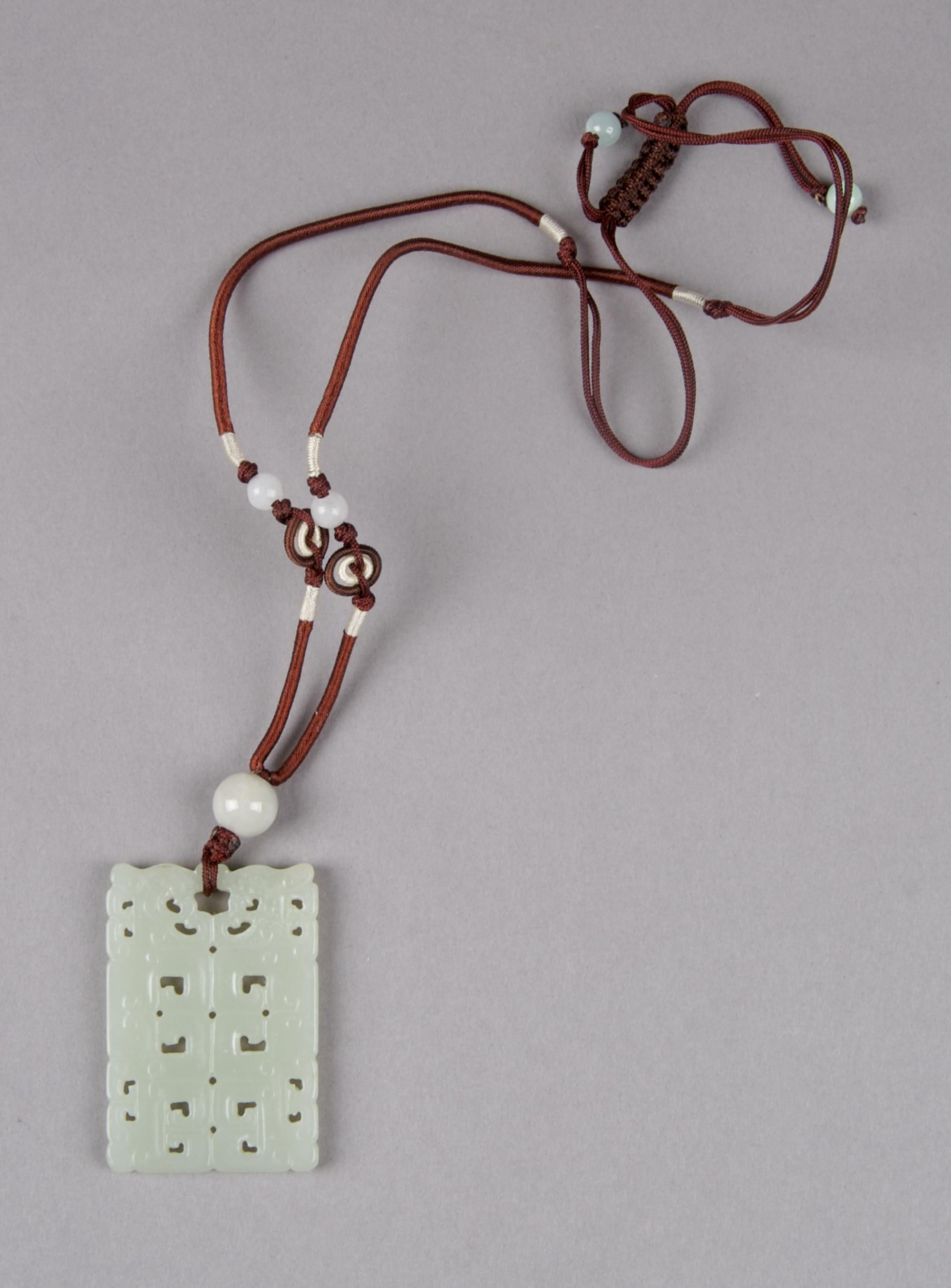 A Celadon Jade Rectangular Plaque, Height 2 inches.
