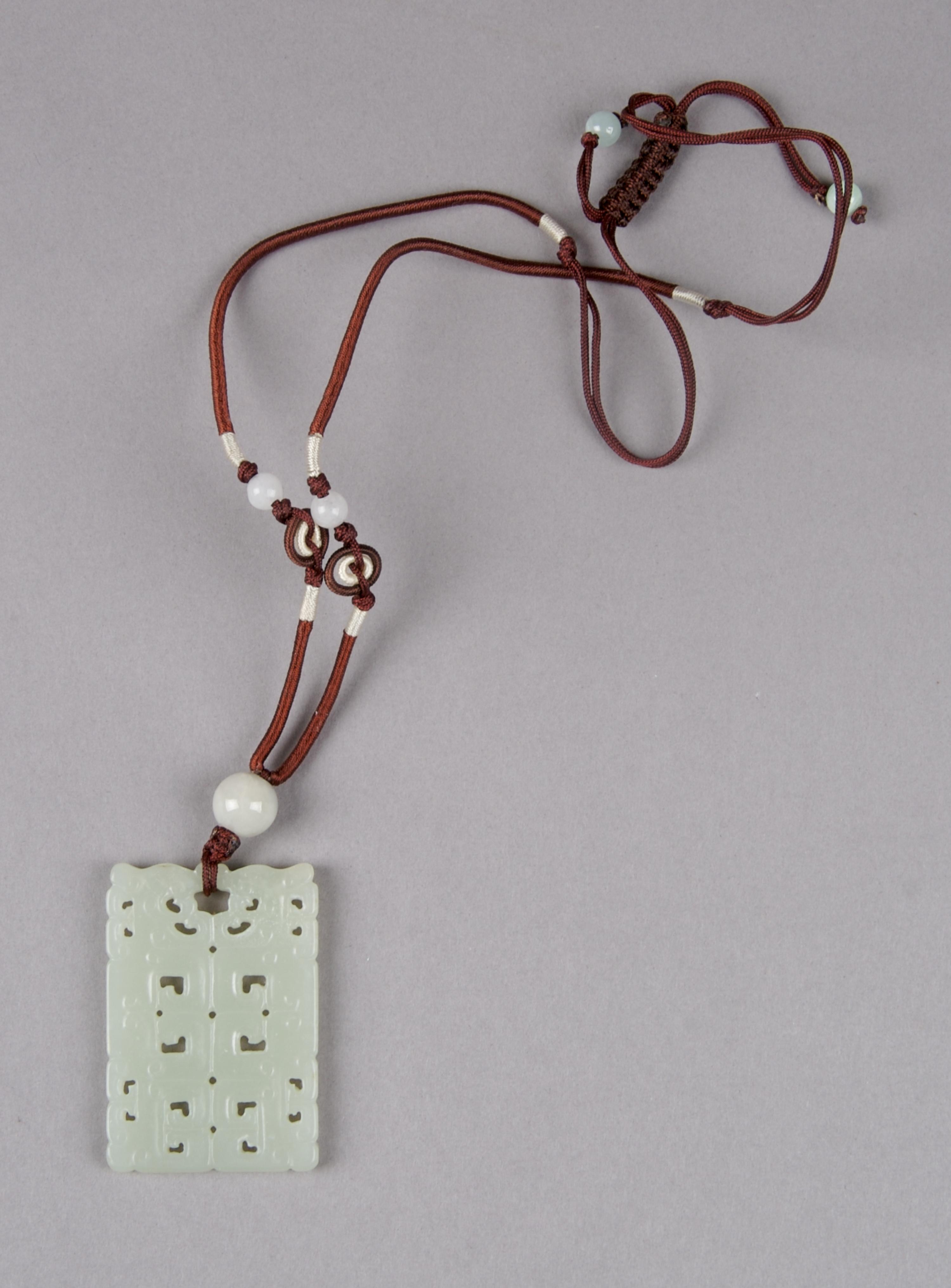 A Celadon Jade Rectangular Plaque, Height 2 inches.
