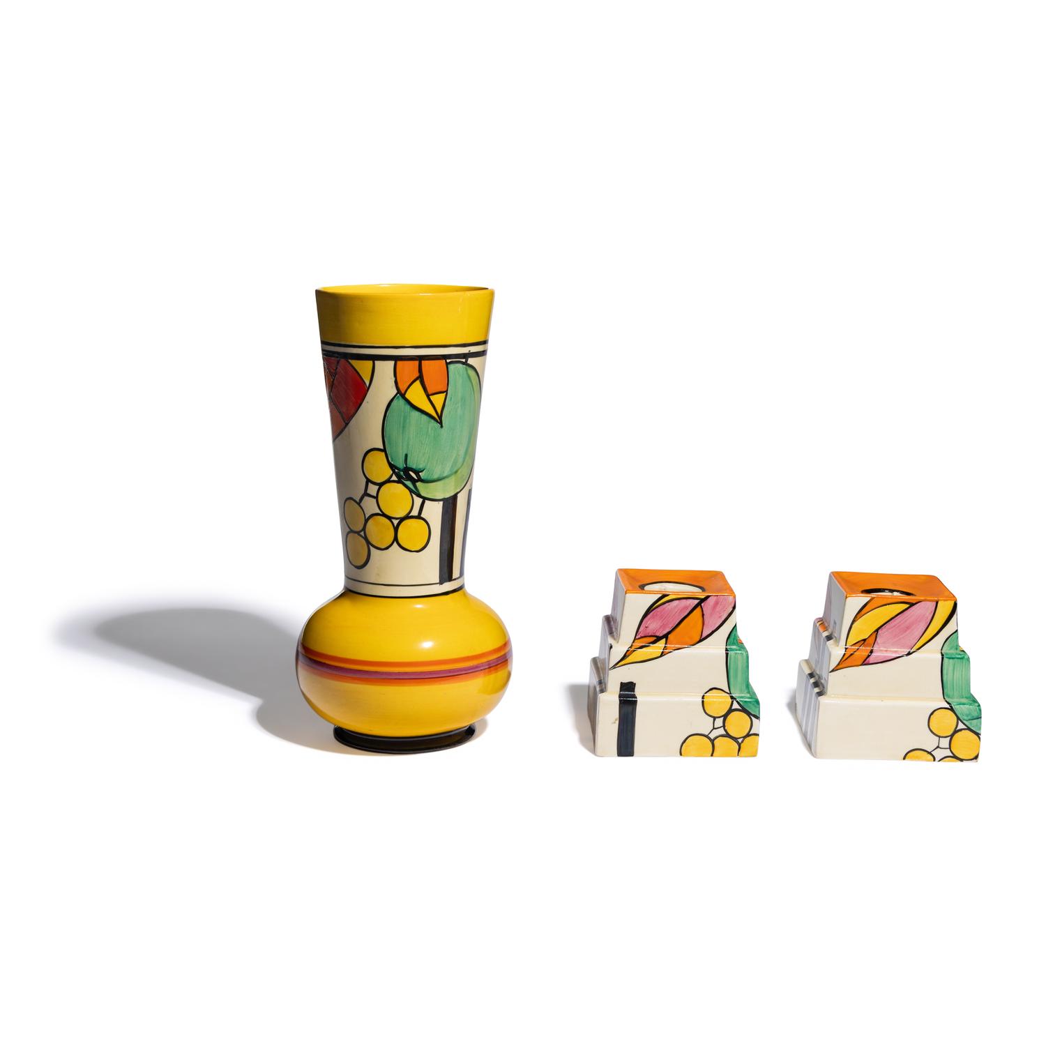 Clarice Cliff (English, 1899-1972) — Apples pattern Vase and two Candlesticks, c. 1931-32