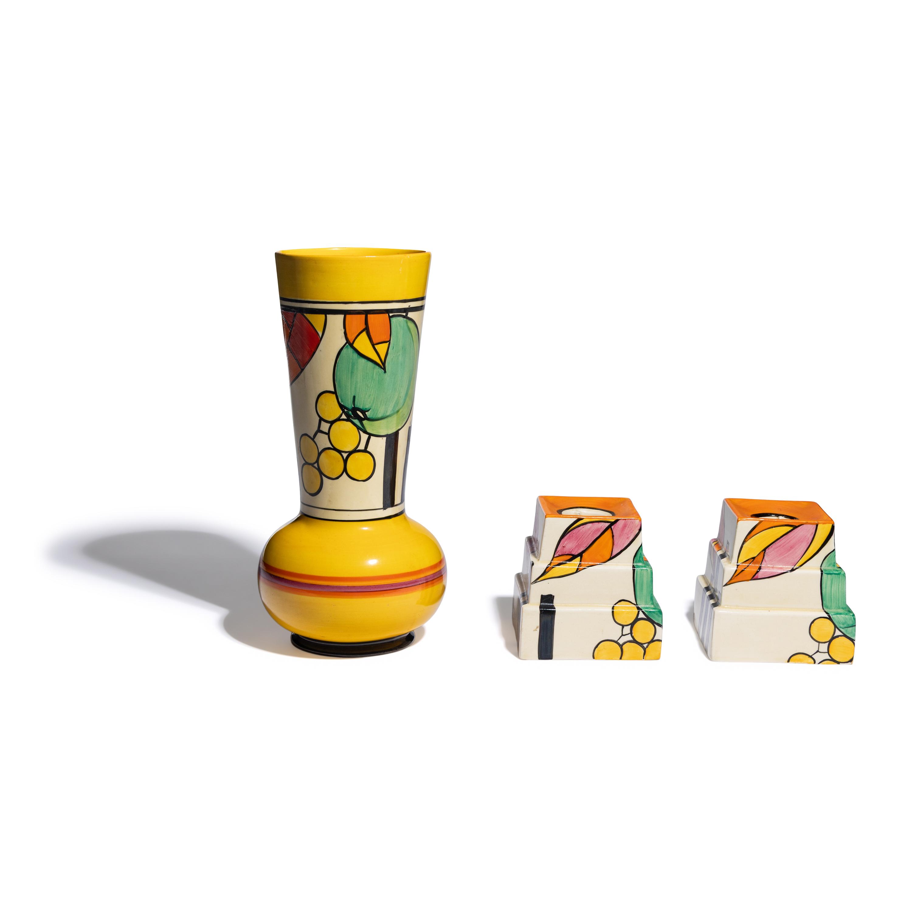 Clarice Cliff (English, 1899-1972) — Apples pattern Vase and two Candlesticks, c. 1931-32