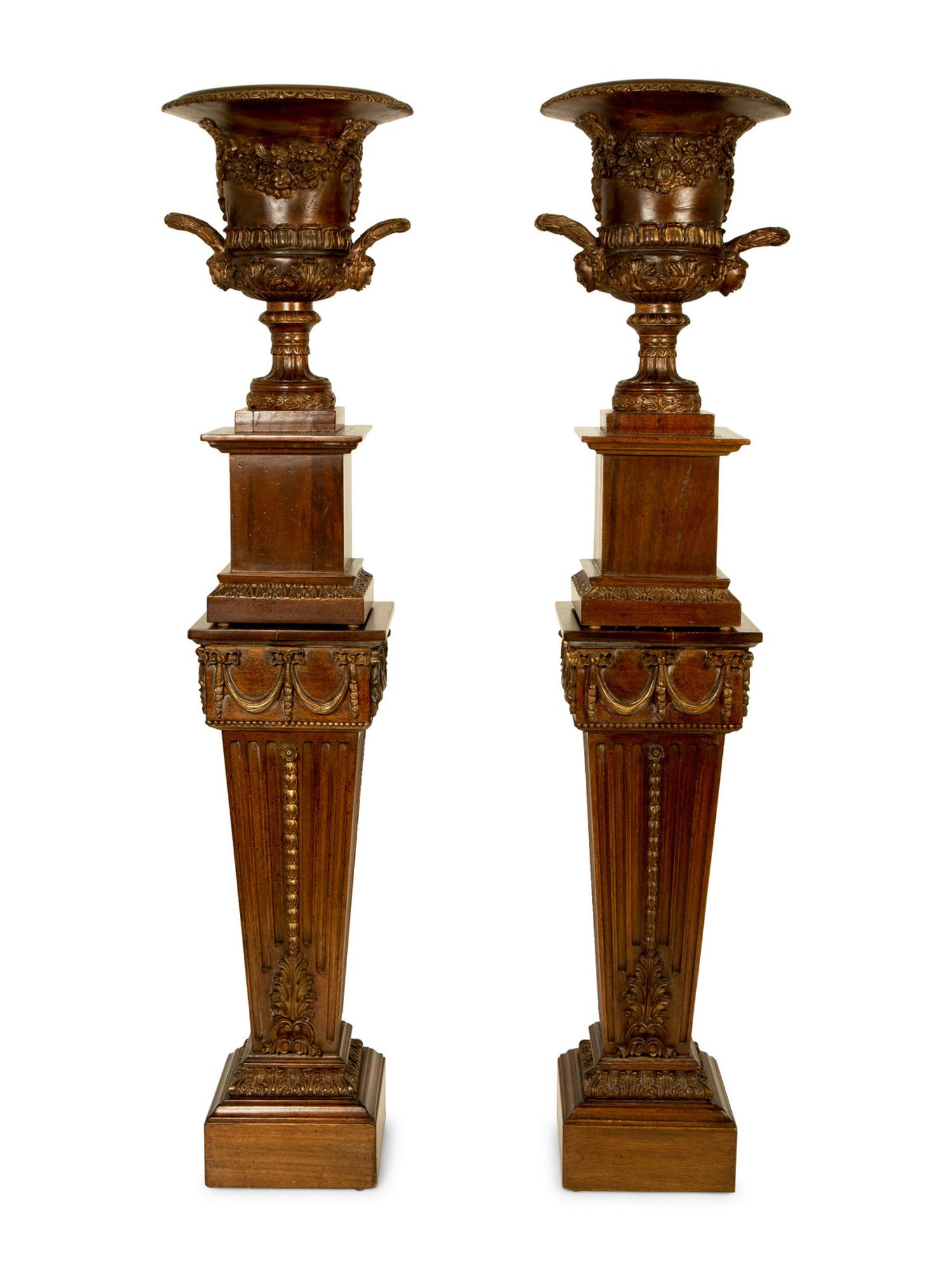 A Pair of George III Style Carved and Stained Wood Campana Urns on Pedestal Stands — 20TH CENTURY