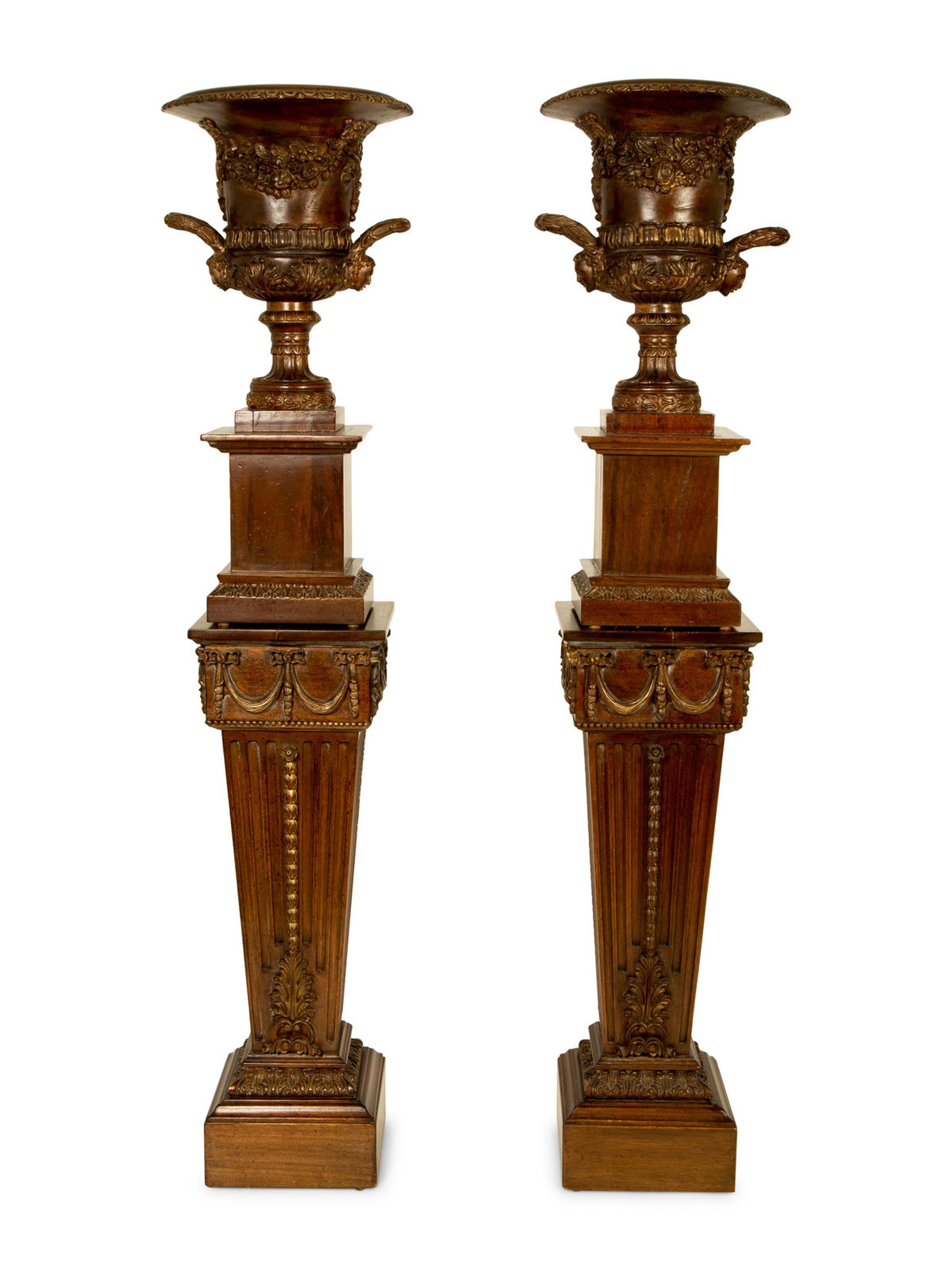 A Pair of George III Style Carved and Stained Wood Campana Urns on Pedestal Stands — 20TH CENTURY